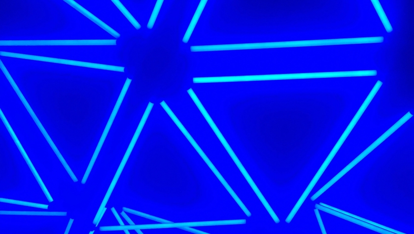 Glowing fluorescent blue triangles in a pattern